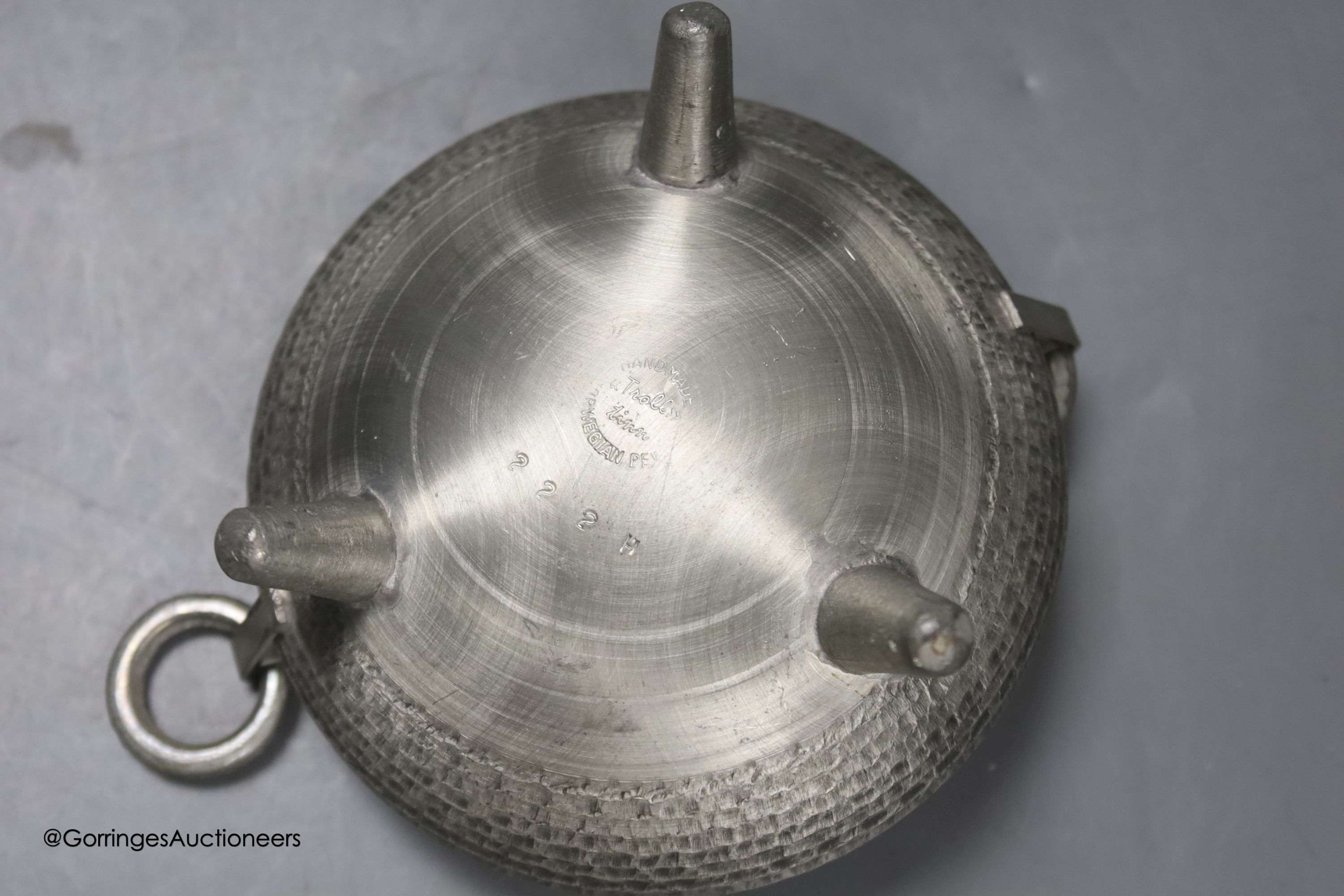 A Liberty & Co Tudric pewter pin dish, a Tudric covered jug and a pewter candleholder